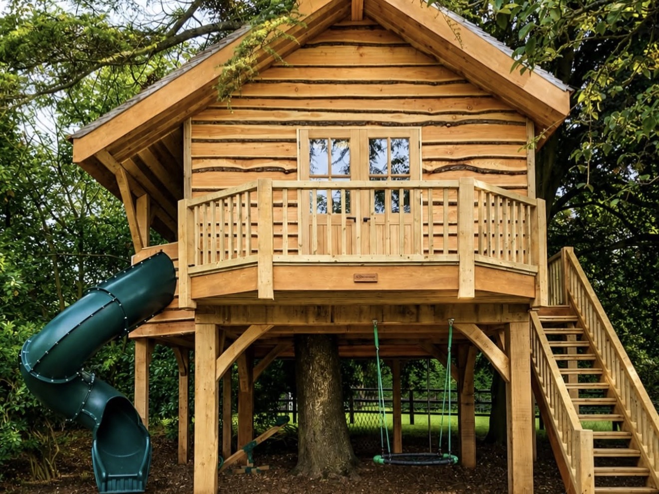 Timber treehouse with balcony and slide built by Josh Spoore in Newmarket